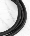 Close-up of black straps for Four Pack Elastic Luggage Straps With Carabiner Hooks Black Polyester Tie Down Straps For Camping, RV, Motorcycle Gear, Tarp, And More, 1 Meter Each, Super Stretchy With Strong Rebound Ready To Roll