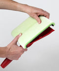 Hands holding a Deck Stain Pad With Groove Tool For Even Coverage On Flat Surfaces And Between Boards showing wrapped edge.