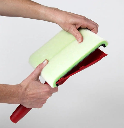 Hands holding a Deck Stain Pad With Groove Tool For Even Coverage On Flat Surfaces And Between Boards showing wrapped edge.