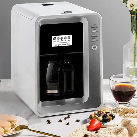Fully Automatic Bean To Cup Coffee Maker With Built In Grinder Removable Reservoir And Smart Thermal Insulation on countertop with coffee and snacks.