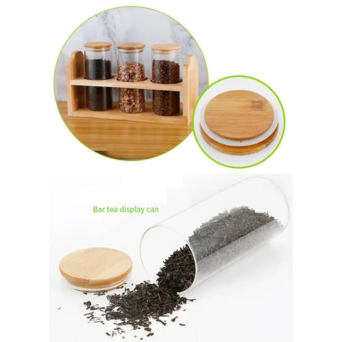 Solid Glass Coffee Containers With Shelf And Hella Secure Lids, Versatile Kitchen Food Storage Jars For Beans Sugar And Tea, 2 Pack with loose tea spilling from jar.