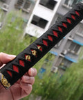 Hand holding DIY Katana Handle Kit Tsuka 10.2 Inch With Alloy Copper Iron Fittings, faux Samegawa, black and red wrap