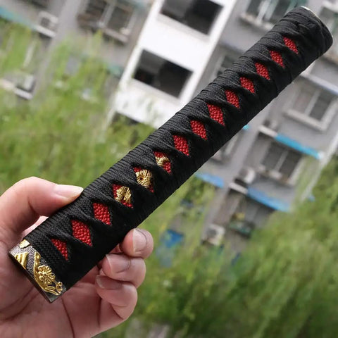 Hand holding DIY Katana Handle Kit Tsuka 10.2 Inch With Alloy Copper Iron Fittings, faux Samegawa, black and red wrap