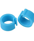 Two blue 100 Pcs Pigeon Leg Bands 8mm Blue Identification Clip Rings Plastic Bird Markers for easy flock identification.