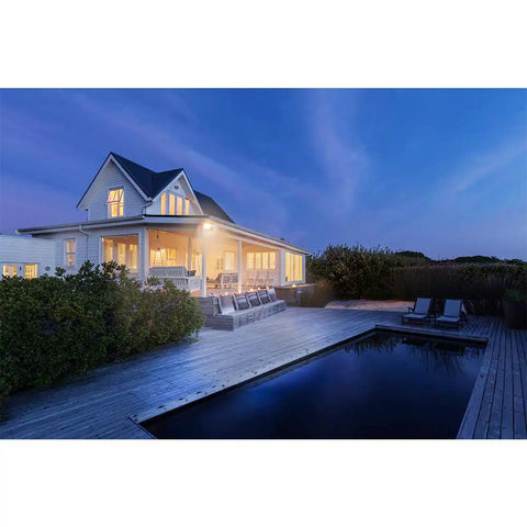 House with Single Head Outdoor Integrated LED Flood Light illuminating patio and pool, selectable color temperature, 5800 lumens.
