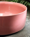 15.7 Inch Round Pink Ceramic Vessel Bathroom Sink Over Counter Vanity Basin with glossy finish on a countertop.