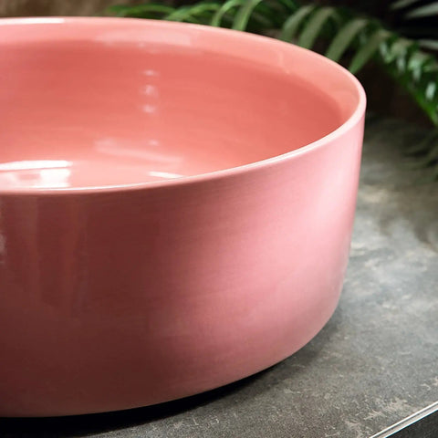 15.7 Inch Round Pink Ceramic Vessel Bathroom Sink Over Counter Vanity Basin with glossy finish on a countertop.