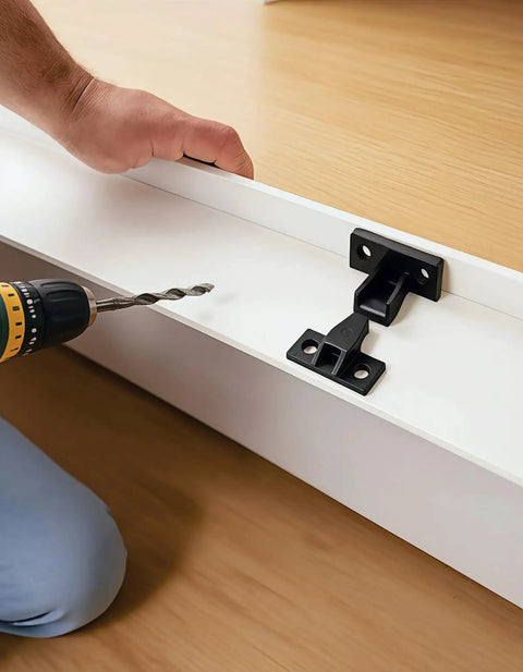 Installing Top Shelf Invisible Panel Connectors with drill on white panel for cabinets and drawers.