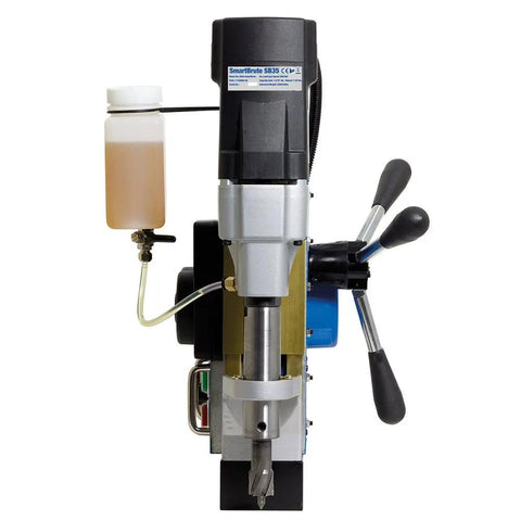 Powerful Pro Grade Automatic Magnetic Drill Press Featuring Slick Auto Feed Variable Speed And Reverse Control For Knockout Precision Holes On Heavy Steel And Pipe. Front view showing drill head, feed controls, and coolant tank.