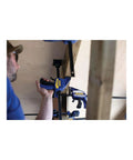 Worker using One-Handed Quick-Change Bar Clamp For Medium-Duty Projects, 12 Inch, 300 Lbs Clamping Pressure, I-Beam Design in workshop.