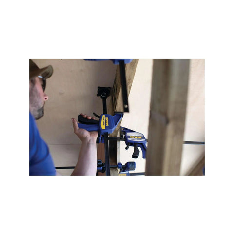 Worker using One-Handed Quick-Change Bar Clamp For Medium-Duty Projects, 12 Inch, 300 Lbs Clamping Pressure, I-Beam Design in workshop.