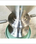 Close-up of stainless steel part of JM120 Commercial Vertical Peanut Butter Grinder Mill in Stainless Steel, showing adjustment markings.