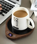 Keep Your Daily Drip Stayin Toasty With This Electric Coffee Mug Warmer Featuring Three Custom Temperature Levels Four Hour Auto Shut Off And Compact Desk Base For Zero Cold Sip Regrets. White ceramic mug on a wooden electric warmer.