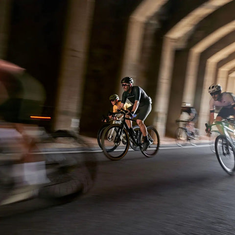 Cyclists racing through a tunnel, capturing motion and speed, showcasing use of Edge 1050 Premium All In One Cycling Computer Gift Box Bundle.