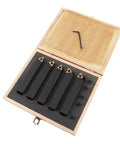 Five black carbide turning tool shanks with indexable inserts in a wooden case; includes hex key and screws