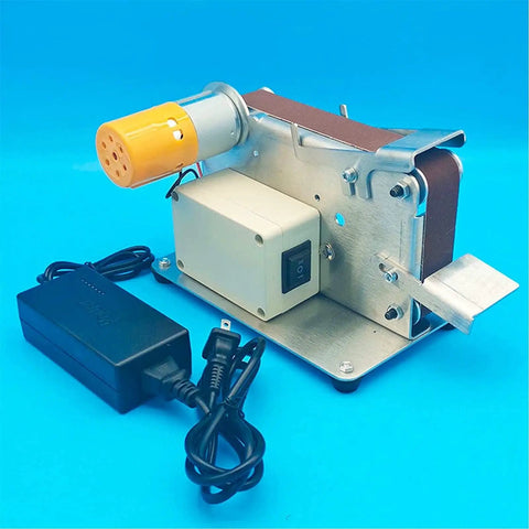Compact Mini Belt Sander With Polishing Wheel And Automatic Tensioning For Desktop Use, showing base, motor, and power supply.