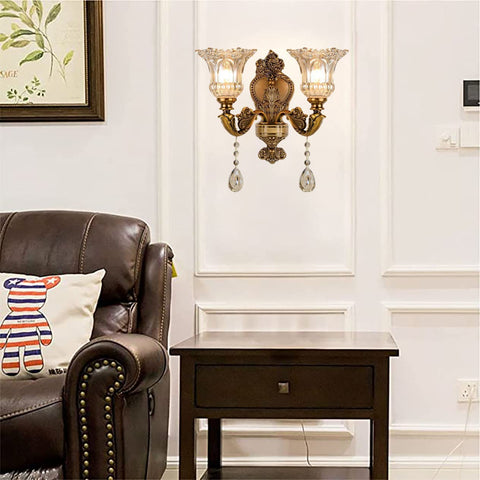 Old-School Antique Brass Wall Sconce With Two Heads, Beveled Crystal Shade, Vintage Floral Design on wall in living room