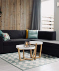 Living room with a modern dark sofa, wooden accents, and Three Light Brushed Nickel Chandelier With Frosted Seeded Glass For Dining Room And Bedroom 18 Inch Diameter Includes 36 Inch Chain And 120 Inch Wire Uses Three Medium Base Bulbs Up To Sixty Watts CETL Listed Five Year Warranty on the wall.