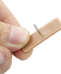 Plastic Nail In Drawer Slides 30 Pack Tack In Glide Replacement Heavy Duty Smooth Motion For Dresser Cabinet Desk Nightstand Easy DIY Fix To Make Stuck Drawers Glide Like A Champ, close-up of a brown plastic glide with a metal nail.