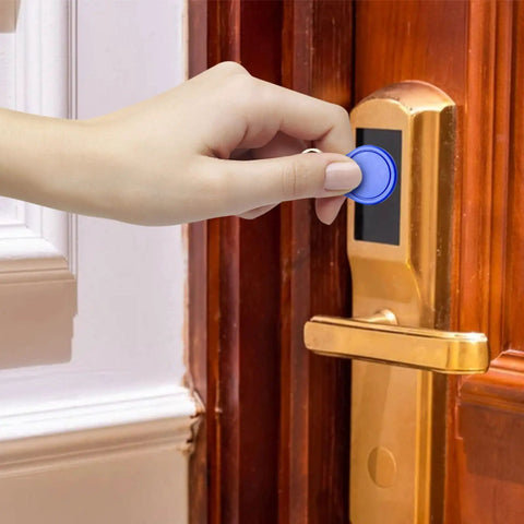 Hand using Rewritable 13.56MHz UID Key Fobs Pack Of 100 For Easy Access Control, NFC RFID Cards for entry on door lock