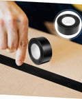Heavy Duty Leak Stop Tape Outdoor Sealing Tape Double Sided Waterproof For Water Pipes, black roll, in use on cardboard.