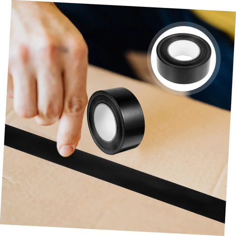 Heavy Duty Leak Stop Tape Outdoor Sealing Tape Double Sided Waterproof For Water Pipes, black roll, in use on cardboard.