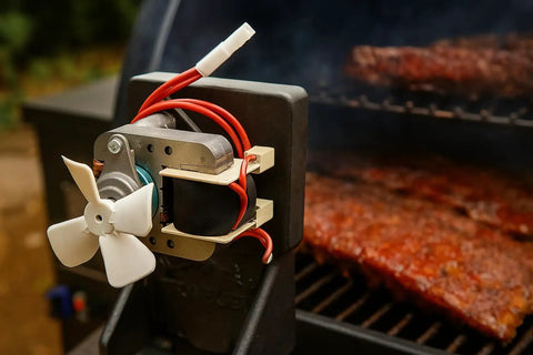 Upgraded Heavy Duty Auger Motor For Pellet Grills Plug And Play Quick Install With Shear Pin And Nut Includes One Year Warranty Silver Finish No Sweat Operation Totally Reliable mounted on grill with fan blades.