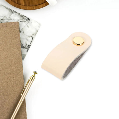 Slick Double Pack PU Leather Cord Organizer Ties For Reusable USB Charger Straps and Earphone Holders, beige cord organizer on desk.