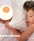 Kid Friendly Toddler Night Light With Star Projector on bedside table next to sleeping child, showing 30-minute timer function