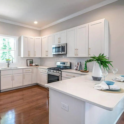 Modern kitchen with white cabinets featuring antique brass stainless steel cabinet handles