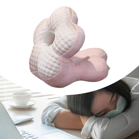 Woman napping at a desk with a Go-To Travel Napping Pillow with Face Cradle, ergonomic pink pillow, 25x25x30 cm.