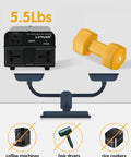 800W Voltage Converter Transformer for travel and home use next to a 5lb dumbbell on a scale image