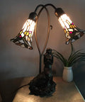 Mermaid And Lily Flowers Tiffany Style Stained Glass Accent Table Lamp 20 Inch Tall Elegant Nightstand Light With Warm White Glow And Classic Vintage Charm E12 Bulbs Not Included, showing a lit stained glass shade with mermaid base on a table.