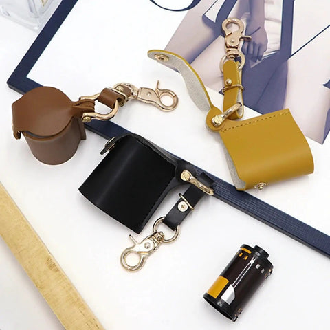 Compact Water Film Holder Case With Keychain Clip And Quick View Waterproof Film Storage Bag For On The Go Camera Gear And Outdoor Shoots Perfect For Photographers, showing brown and black film holders with keychain clips