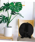Waterproof Oxford Cloth Drum Backpack With Dead Easy Padded Straps And Adjustable Instrument Gig Bag For Built Different Road Ready Heavy Duty Music Gear Travel Setup Pro Grade Shock Proof Bag on chair with plant background.
