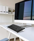 Two Pack Tilted Keyboard Stand In Clear Acrylic For Ergonomic Typing shown on desk setup with computer monitor