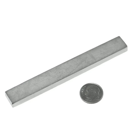 Ultra Strong Neodymium Magnet N42 Block 4 X 1/2 X 1/4 In Permanent Rare Earth Magnet next to a dime for size comparison