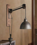 Badass Industrial Pulley Wall Sconce Featuring Solid Black Iron Rope Lighting, showcasing matte black shade and wood wall mount.