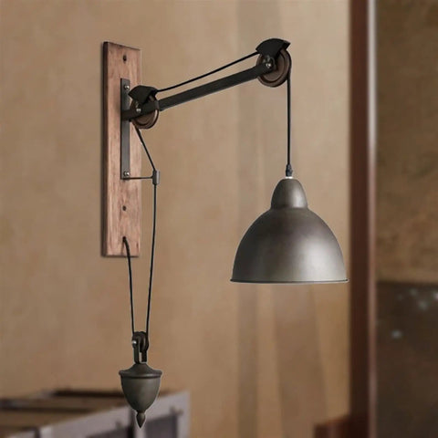 Badass Industrial Pulley Wall Sconce Featuring Solid Black Iron Rope Lighting, showcasing matte black shade and wood wall mount.
