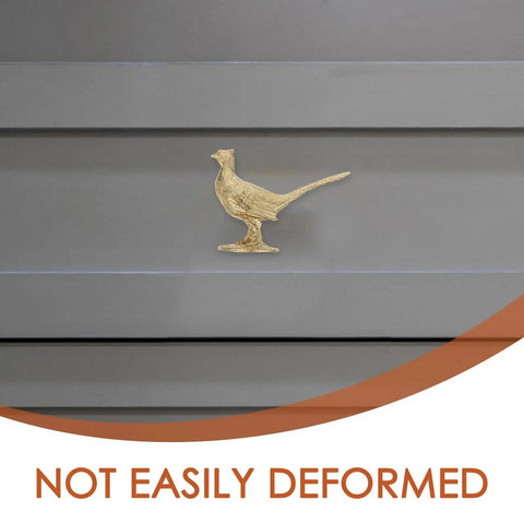 Top Shelf Brass Pheasant Drawer Knob With Rich Golden Finish on gray cabinet door, showcasing intricate bird design, tarnish proof.