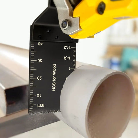 Close-up of titanium-coated oscillating tool blade cutting plastic pipe, part of Titanium Coated 31 Piece Oscillating Tool Blades Set.