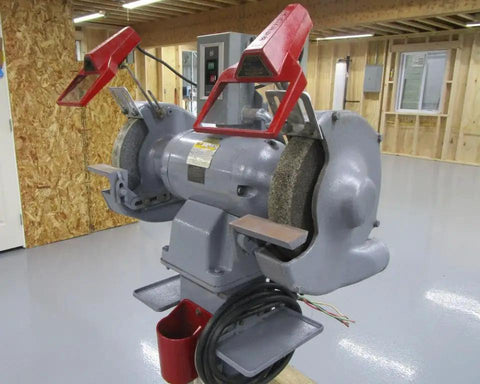 Shop Beast 12 Inch Bench Grinder Fueled by a 3 Horsepower 3 Phase Motor with Versatile 208 230 460 Volt Support Crushing Metals at 1500 1800 Rpm in a workshop setting.