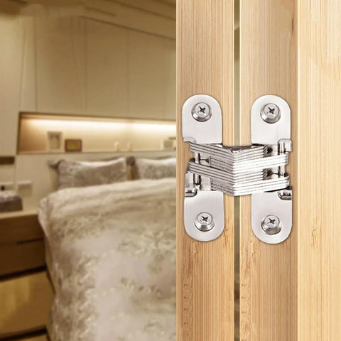 Concealed Cross Hinges Set Of Two In 304 Stainless Steel installed on wooden door in upscale kitchen or club setting.