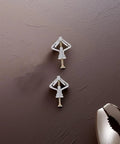 Two Heavy Duty Drywall Anchors and Screws Kit with Sturdy Plastic and Steel 50 Sets Butterfly Anchors on a brown surface