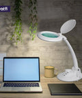 All In One LED Magnifying Lamp with Dust Cover, 5 Inch Glass Lens, Dimmable on desk with laptop, showcasing glare free light.