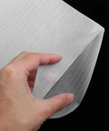 Close-up of a hand holding Epe Foam Pouches 200 Pack For Moving And Shipping Cushioned Protection, showcasing the white foam material.