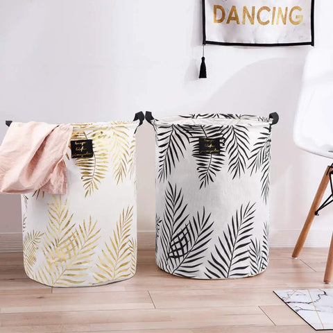 Decorative collapsible laundry hampers with leaf patterns, highlighting home organization and style.