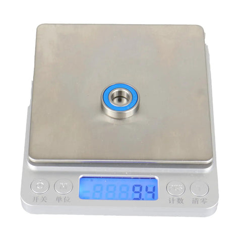 One Set Of 10 6900 2RS Bearings ABEC 5 Precision on scale showing weight, pre lubricated double rubber seals, 10x22x6mm.