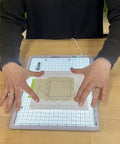 Hands using Portable LED Light Pad For Crafting And Quilting 10 By 13 Inch, Ultra Bright Four Level Illumination for tracing.