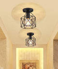 Retro Black Industrial Ceiling Light Fixture Mini Metal Rustic Flush Mount illuminating a hallway with warm light